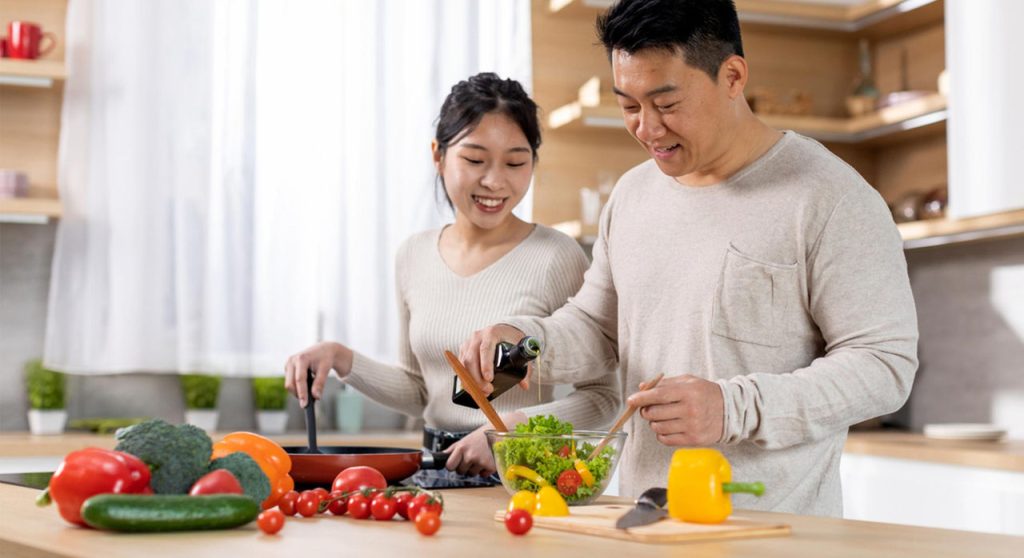 smiling-couple-making-salad-2200x1200.jpeg